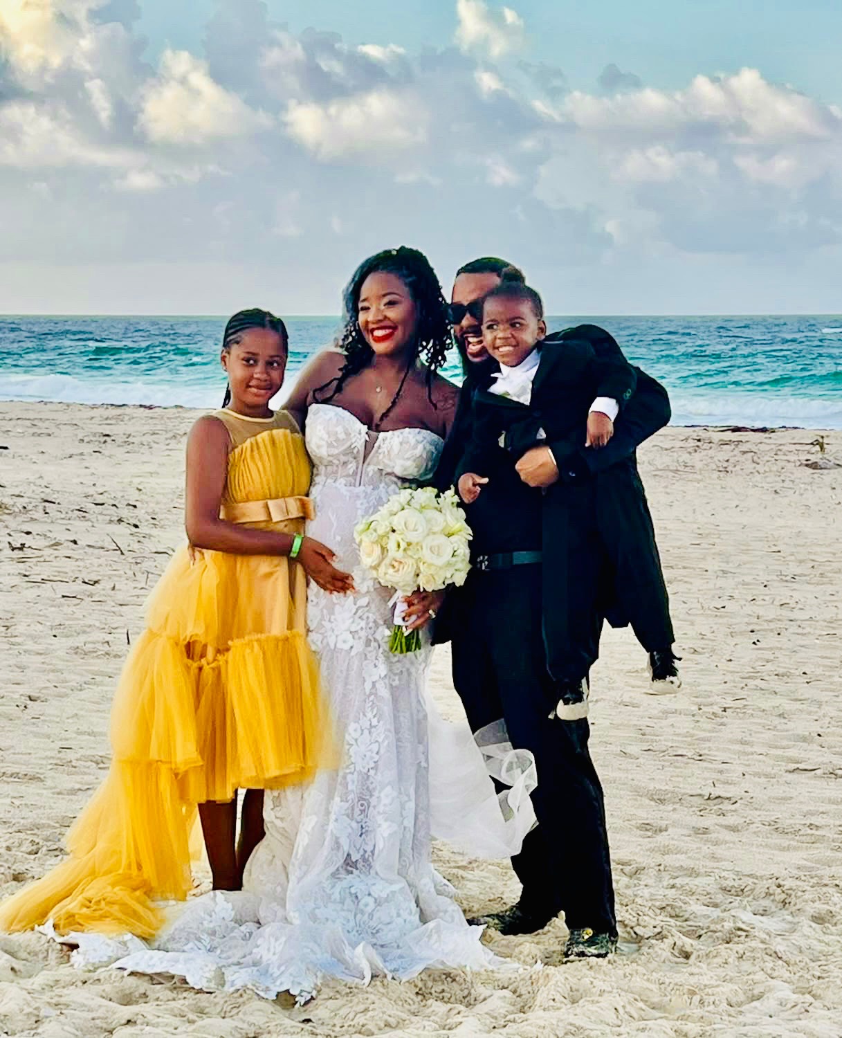 Jaytee Miller with his wife and children on the beach at their wedding